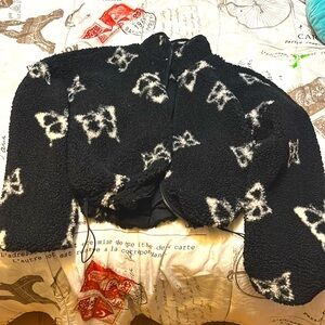 It’s black, with white butterflies, and only  been used once